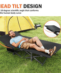 Camping Cot With Cushioned Comfort For Adults, gray portable bed with head tilt design, used outdoors by a tent