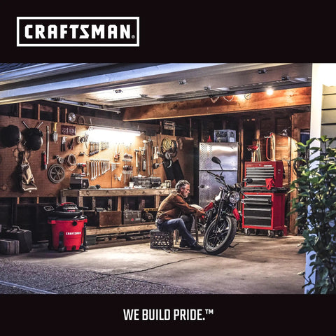 Person working on motorcycle in workshop with tools and Craftsman red tool chest, emphasizing dedication and craftsmanship.