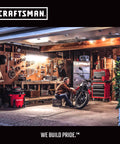Person working on motorcycle in garage with Craftsman tools and equipment.