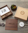 Wooden keepsake box set with photo frame, engraved names, and ribbon on rustic wood surface