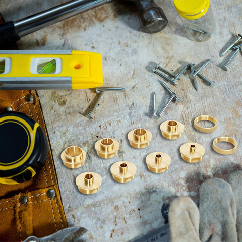 Front view: brass router template guide bushings set of 10 on a wooden bench with nails and a yellow level.