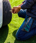 Person using Permanent Tire Repair Kit For Cars Motorcycles Off Road Vehicles Trailers SUVs Pickups ATVs UTVs And Scooters Easy To Use No Fuss Quick Fix With Dry Vulcanized Patches on a car tire outdoors.