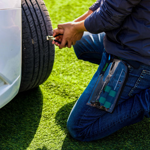 Person using Permanent Tire Repair Kit For Cars Motorcycles Off Road Vehicles Trailers SUVs Pickups ATVs UTVs And Scooters Easy To Use No Fuss Quick Fix With Dry Vulcanized Patches on a car tire outdoors.