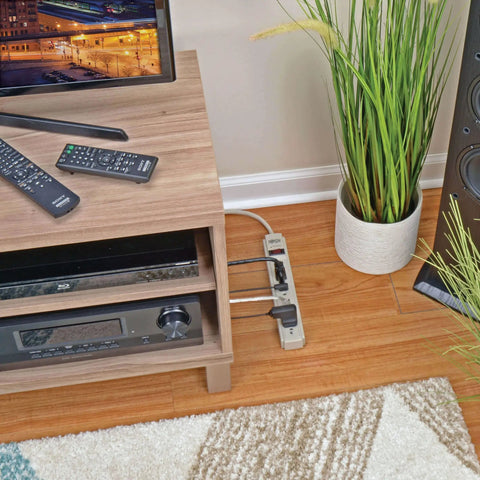 Must Have Surge Protector Power Strip With Six Outlets, Eight Foot Cord, 990 Joule Rating, Flat Plug, 120V Gray next to TV stand