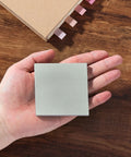 Hand holding a 3x3 inch pad from Sticky Notes Bulk Pack 3x3 Inches 12 Pads 600 Sheets Vintage Colors Self Stick Note Pads