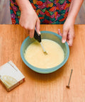 Person using Portable Mini Mixer With Four Attachments For Beating Eggs Whipping Cream Mixing Dressings And Frothing Drinks Lightweight Easy To Use Black Ideal For Meringue Smoothies And Coffee Froth At Home Or On The Go in a bowl.