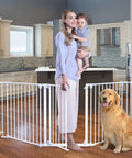 Woman holding child with dog by Deluxe Walk Through Pet Gate For Stairs And Doorways One Hand Operation Hardware Mounted Extra Wide Opening