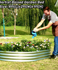 Man watering plants in Two Pack Raised Garden Bed For Outdoor Use Made From Galvanized Steel, Easy Tool Free Assembly, Planter Box For Veggies, Flowers And Herbs, Sturdy Rust Resistant Garden Bed 4 By 2 By 1 Feet installed in backyard