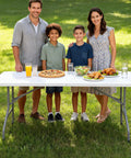 Family enjoying meal on 6 Ft Folding Table Outdoor Indoor Plastic Square Dining Table Portable No Assembly Easy Setup For Picnics Parties Camping White Lightweight Durable Great For Home Tailgating And Events
