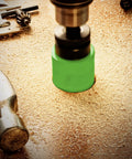 Close-up of a green hole saw cutting wood with 18 Piece Bi Metal Hole Saw Kit With Beefy Cutters And Carrying Case For Metal Wood Plastic