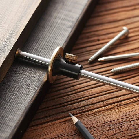 Wheel Marking Gauge With Two Extra Blades And Laser Engraved Graduations And A Solid Brass Face Adjustable For Precise Parallel Layouts On Wood Projects Must Have For DIY Woodworking used on wood surface with pencil and screws visible.