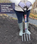 Neverbend Carbon Digging Fork for Heavy-Duty Yard Work in use, showcasing supergrip handle and carbon steel tines for tough soil.
