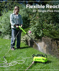 Person using Ultra Compact 1700 PSI 1.2 GPM Pressure Washer for quick no fuss home cleaning on garden pathway.