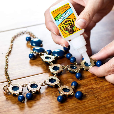 Person applying Super Glue Gel Clear 20 Gram Pack Of 2 All Purpose Fast Setting Adhesive For Glass Plastic Wood Metal Ceramic Rubber Leather Bonds On Vertical Surfaces And More to jewelry