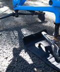 Bike on Flipstand Compact Bike Stand with Tool Storage, featuring saddle protector, handlebar stabilizers, on outdoor surface.
