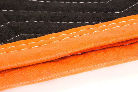 Close-up of Heavy Duty Padded Moving Blankets 72 Inch By 80 Inch Pack Of Twelve, showing double-stitched black and orange polyester material