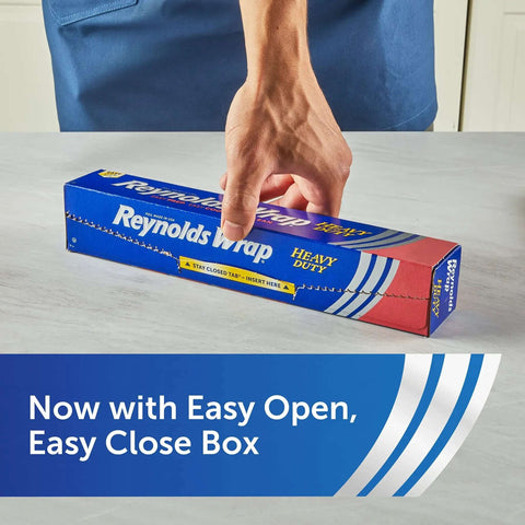Person holding Heavy Duty Aluminum Foil Roll Beefy Strength 12 Inch Wide 50 Square Feet With Secure Easy Open Tab package on table