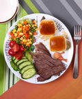 10 Inch Portion Control Plate For Balanced Eating With Melamine Dividers And A Healthy Nutrition Plate For Adults And Teens With Protein Portion Guides Low GI Carbs Vegetables And Fat Portions For Weight Loss And Type 2 Diabetes Management displaying a meal with beef, vegetables, and rolls on a colorful tablecloth