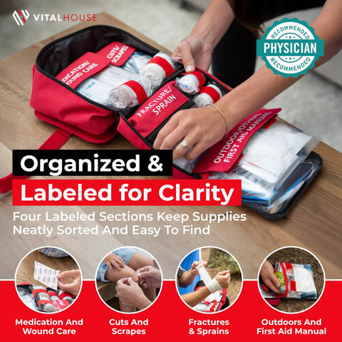 Front view of red VitalHouse 346-piece first aid kit with labeled compartments in a waterproof bag.