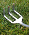 Mr. Pen mini hand rake, metal three-prong garden tool lying in grass