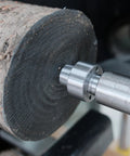 BMWOOD MT2 woodturning lathe drive center installed in a wooden workpiece, close-up view.