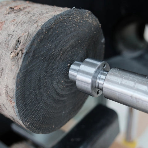 BMWOOD MT2 woodturning lathe drive center installed in a wooden workpiece, close-up view.