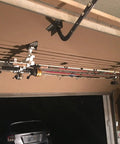 Easy Clip Garage Door Storage Rack With Hooks For Fishing Rods Kayak Paddles And Light Garden Tools Installs In Seconds No Tools Needed Clips To Garage Door Hinge Tubes For Quick No Fuss Organization showing fishing rods stored on a garage door rack