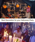 Spooky LED Floating Candles With Wand Remote 12 Pack hanging in Halloween party setting with decorations.