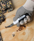 Heavy Duty Staple Remover Tool Featuring A Sturdy Stainless Steel Lifter For Upholstery Furniture Fixes And Crafts Dead Simple No Sweat Pulling Power in use on wood.