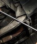 Mechanic using 24 Inch Half Inch Drive Breaker Bar With 180 Degree Flex Head In Hardened Cr-V Steel Beefy Heavy Duty Chrome Plated Finish For Rust Resistant Lug Nut Breaks And Easy Torque At Any Angle under a car.