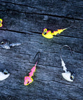Crappie Jig Heads Multi Pack With Realistic Head Design And Sharp Hooks For Solid Hookups In One Eighth Ounce Size With Size Two Hooks With Multiple Colors Perfect For Crappie Fishing With Natural Swim Action And Versatile Performance on wooden background