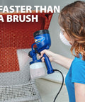 Person using Finish Max HVLP Electric Paint Sprayer for Cabinets, Furniture and Trim with Brass Tip on wicker chair