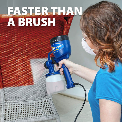 Person using Finish Max HVLP Electric Paint Sprayer for Cabinets, Furniture and Trim with Brass Tip on wicker chair