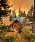 Scenic view of a cabin surrounded by trees during a sunset. Ideal setting for Wildfire Protection Sprinkler System With Bracket And Hardware.