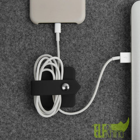 Headphone Case And Cable Organizer For Earbuds And Headphones Cord Winder And Earphone Holder Case Wrap Winder Headset Keeper Cable Manager Portable Silicone Black Cover in use organizing phone cable with snap closure on gray surface