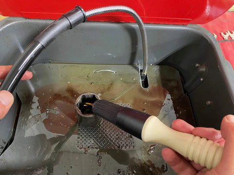 Close-up of Parts Brush Oriflo with Hose, beige handle and black brush head, 28-inch hose