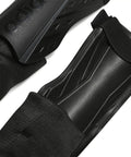Close-up of black Soft Ground Soccer Shin Guards With Pro Grade EVA Shield, featuring durable black shielding and strap details.