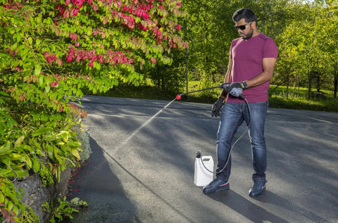 Man using Go-To Rechargeable Power Wand With 3 Way Spray Nozzle And 3.6V Lithium Ion Battery, Includes Charger, Universal 38mm Bottle Adapter