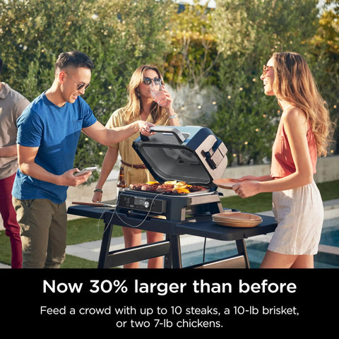 Friends enjoying barbecue with Woodfire Pro Connect Deluxe XL Backyard Grill and Smoker With Bluetooth App Control 7 in 1 Master Grill