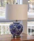 Blue And White Floral Ceramic Table Lamp With White Linen Shade And Brushed Nickel Accents 3 Way Lighting Ginger Jar Inspired Cozy Decor For Living Room Or Bedroom Soft Warm Glow And Timeless Charm displayed on table