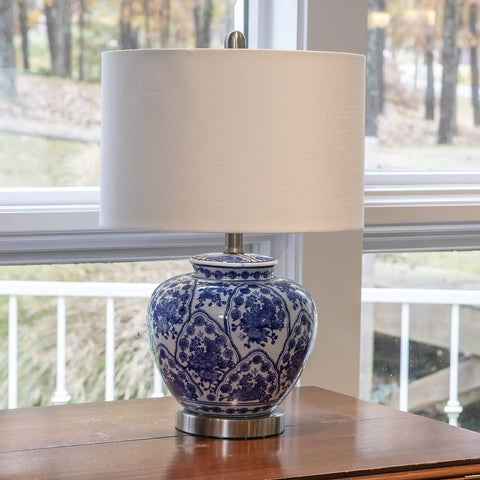 Blue And White Floral Ceramic Table Lamp With White Linen Shade And Brushed Nickel Accents 3 Way Lighting Ginger Jar Inspired Cozy Decor For Living Room Or Bedroom Soft Warm Glow And Timeless Charm displayed on table