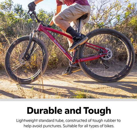 Cyclist on trail with replacement 26 inch bike inner tube with Schrader valve for 1.75 to 2.125 inch wide mountain tires