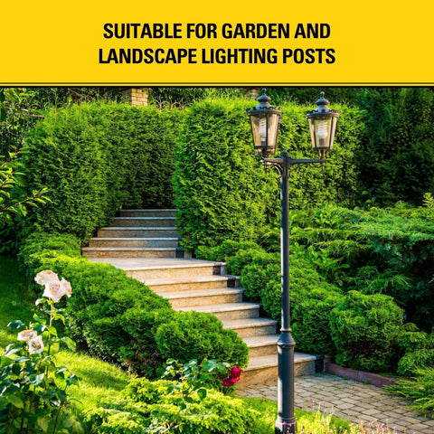 Garden path with stone steps and black metal lamp post surrounded by lush greenery, suitable for outdoor lighting.