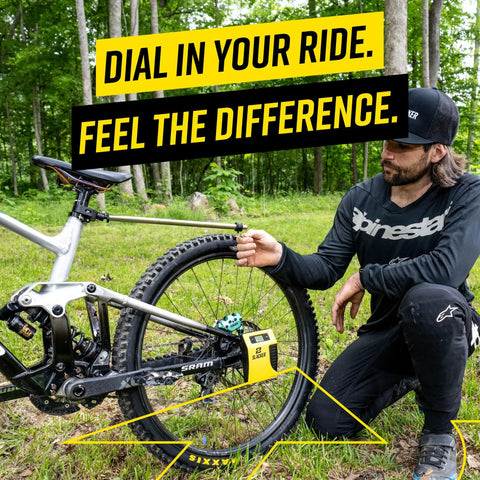 Man using MTB Sag Tool Pro Digital Suspension Tuning Kit With One Person Axle Measurement on a mountain bike.