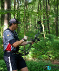 Archer in forest using Fusion-II 2.1 Inch Pink Arrow Fletching Vanes, 36 Pack, Go-To Target Archery Vanes With Tri-Fusion Adhesion Technology