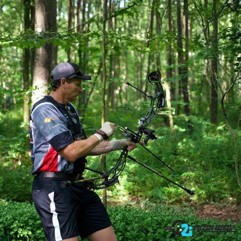 Archer in forest using Fusion-II 2.1 Inch Pink Arrow Fletching Vanes, 36 Pack, Go-To Target Archery Vanes With Tri-Fusion Adhesion Technology