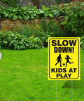 Slow Down Kids At Play Signs With Metal Stakes Four Pack 12 By 16 Inch Double Sided Caution Signs in a garden yard