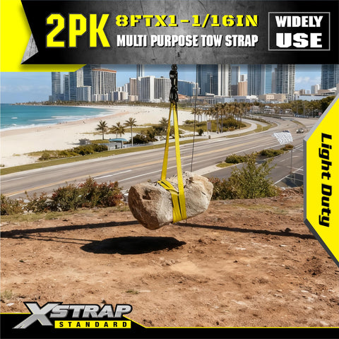 Two Pack 1 Inch By 8 Foot Beefy Lift Slings With Wear Guard Ends demonstrating hoisting a large stone over beach view