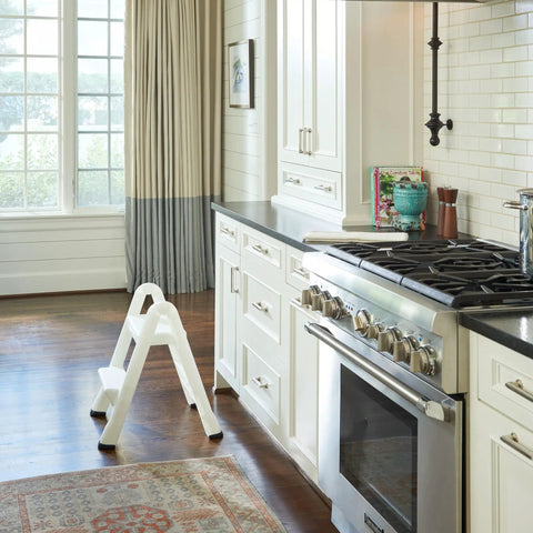 Two Step Folding Foot Stool, 14 Inch High, 300 Pound Capacity, in a kitchen near stove, rust and dent resistant design.