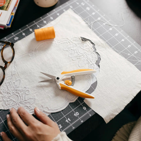Micro Tip Spring Assisted Scissors For Precision Fabric Cutting With Stainless Steel Blades And Comfort Handle Ideal For Sewing Crafting And Detail Work on cutting mat
